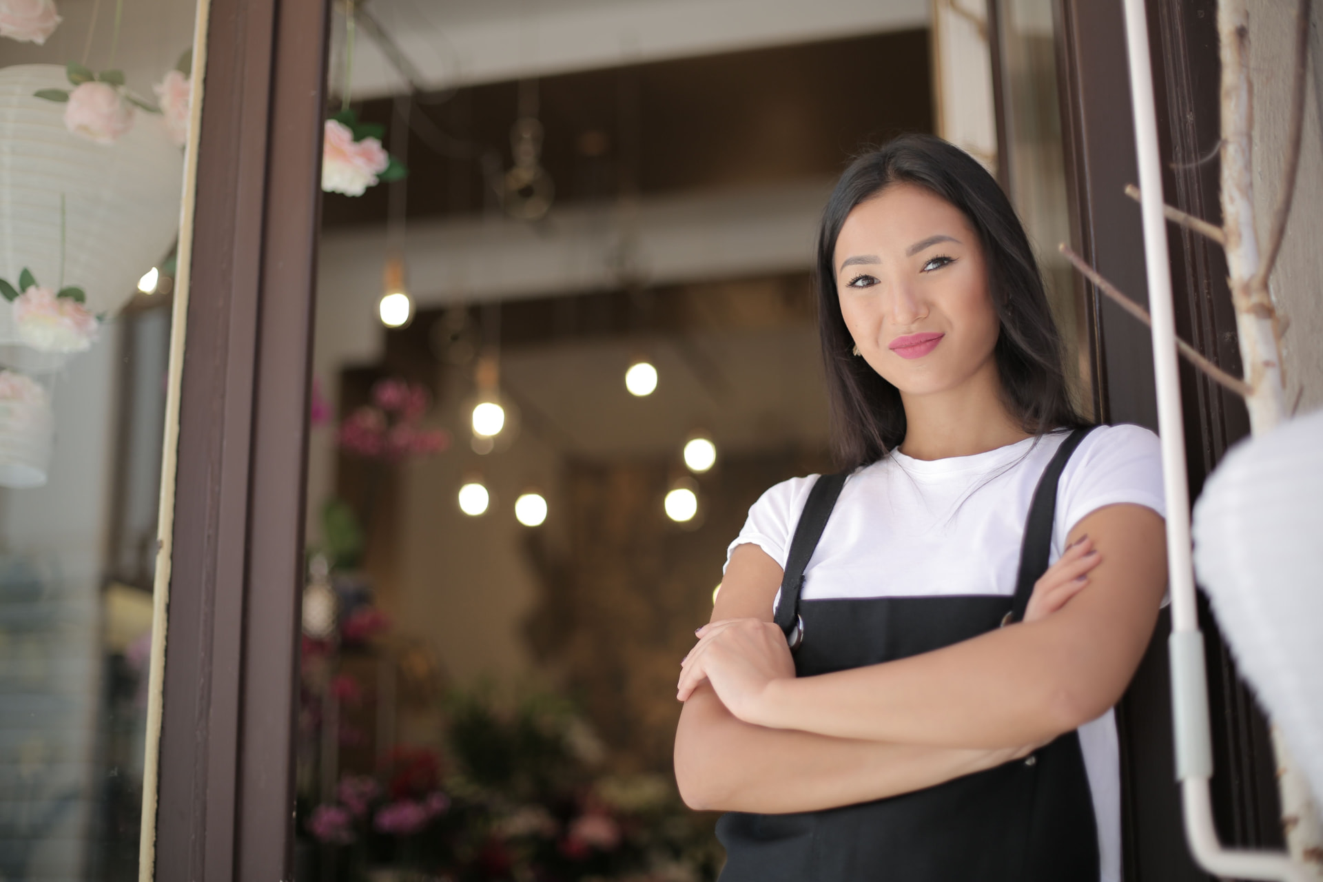 Small business owner standing in the doorway of her shop