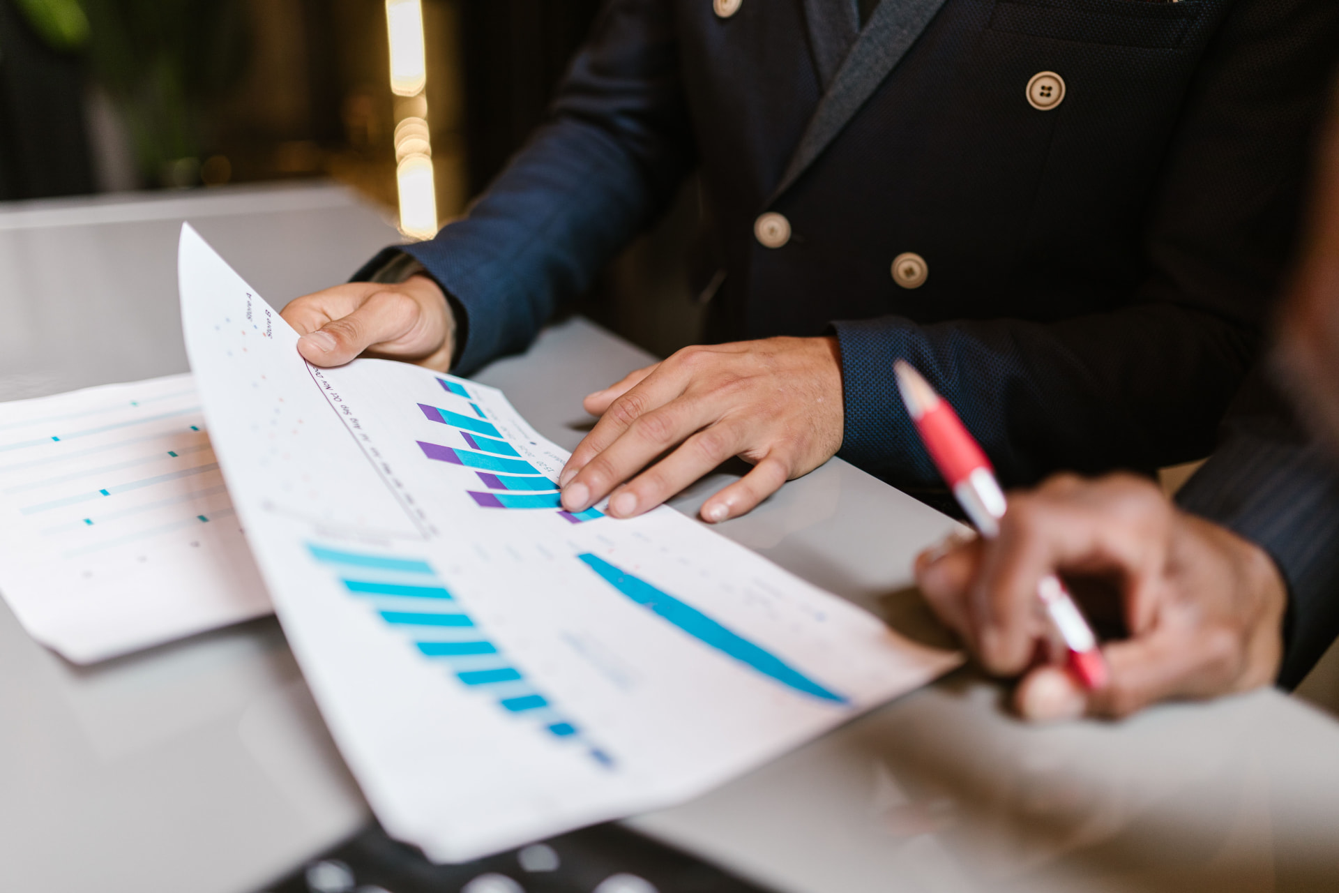 Executive reviewing a printed performance report at a desk
